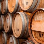 Double A Bourbon branding on oak barrel backdrop