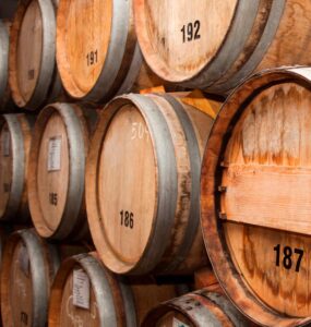 Double A Bourbon branding on oak barrel backdrop
